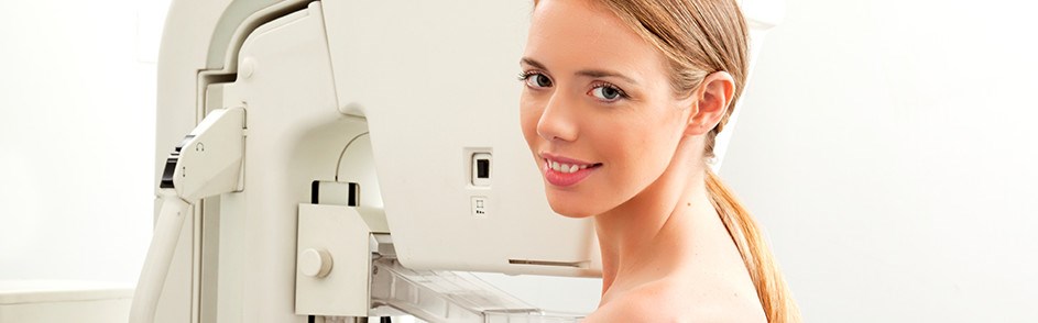 Woman smiling in front of medical machine