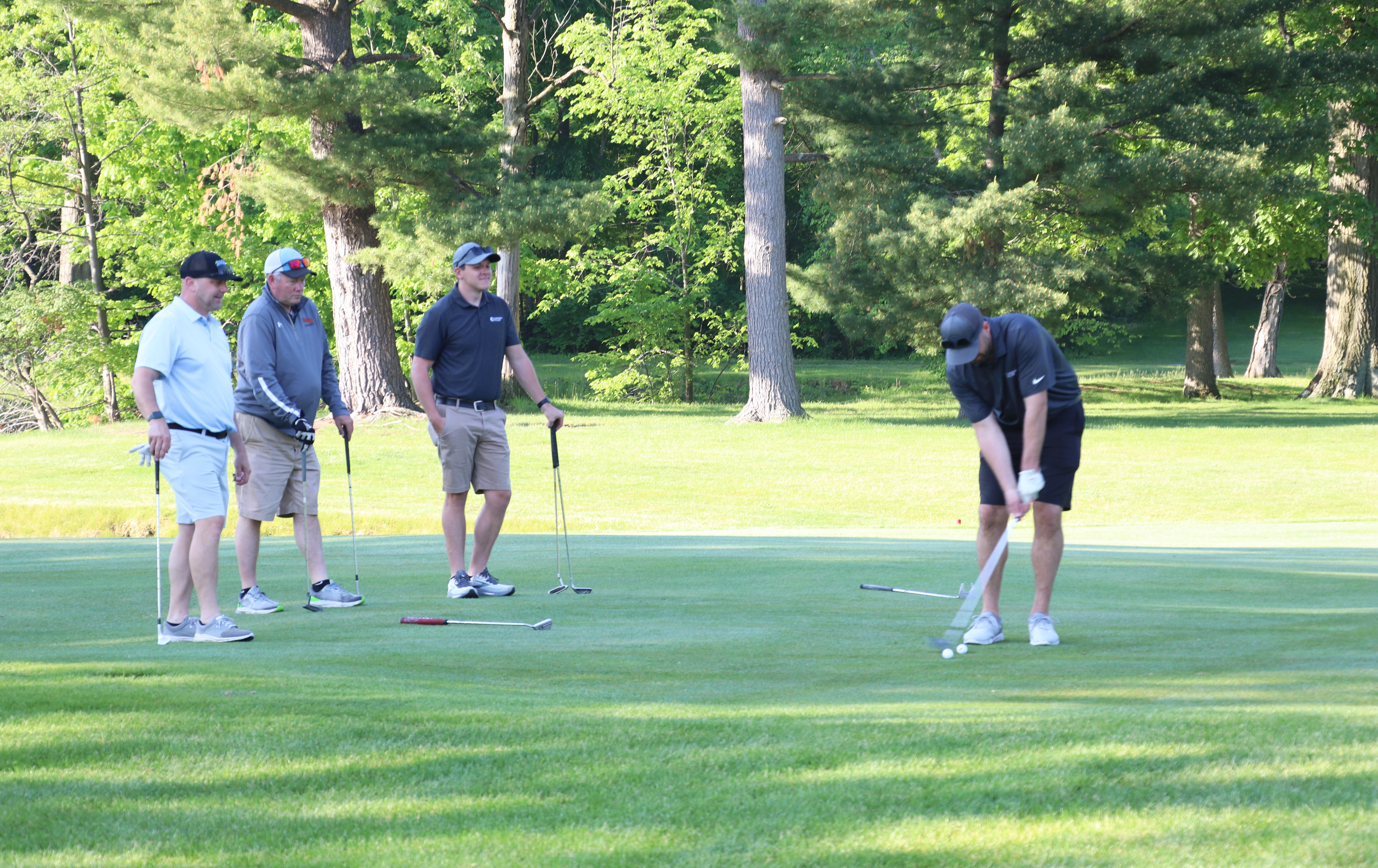4 golfers on green