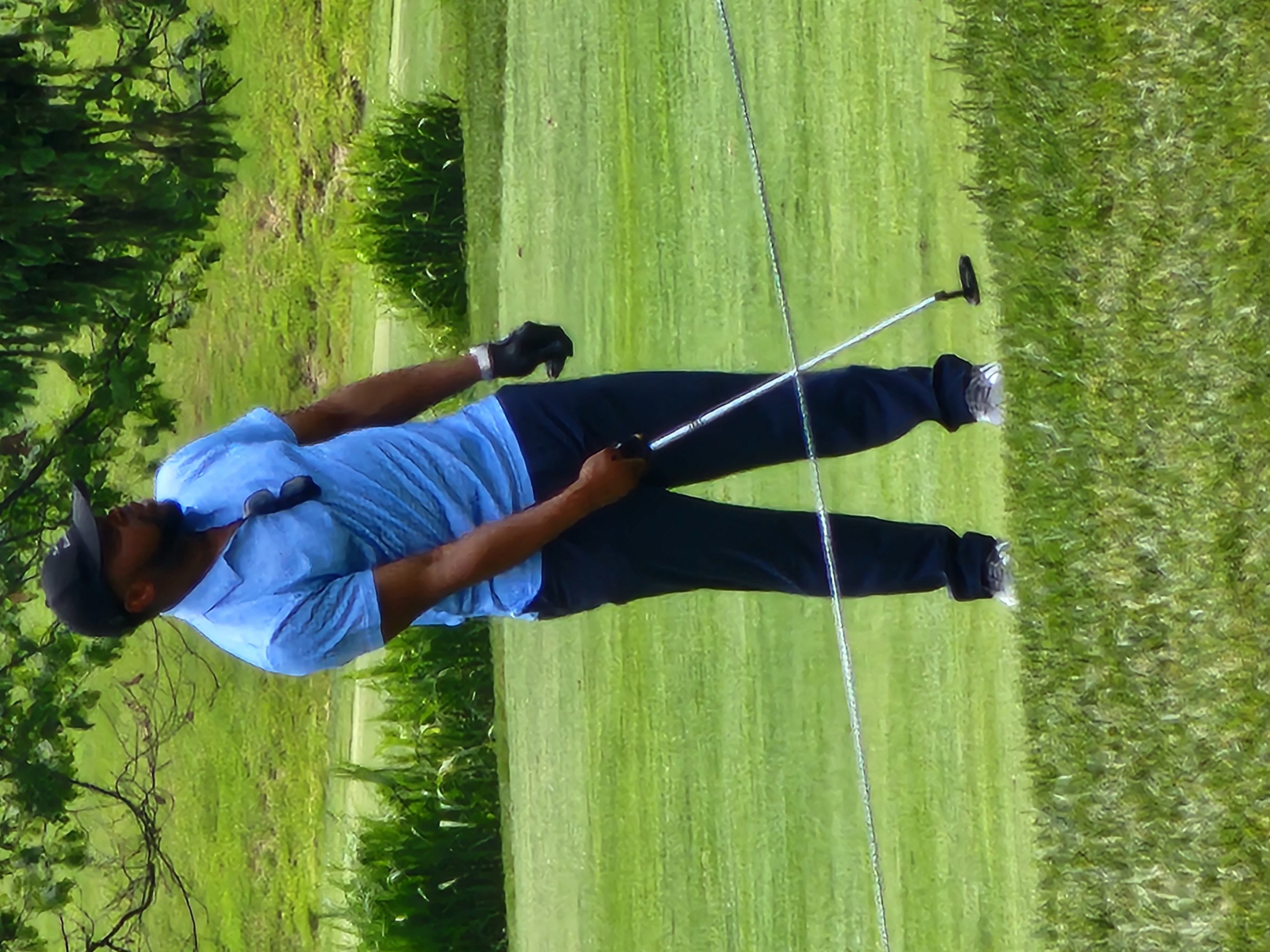 Dr. Nonzo Ezema watching golf ball